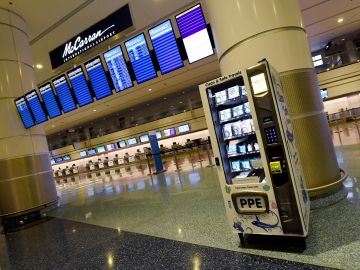 LAS VEGAS, NEVADA - MAY 14:  A personal protective equipment vending machine is set up in the Terminal 1 ticketing area at McCarran International Airport on May 14, 2020 in Las Vegas, Nevada. The airport used its social media platforms on Thursday to report that it was the first to install the machines that sell items such as masks, gloves and hand sanitizer. The nation's 10th busiest airport recorded a 53% decrease in arriving and departing passengers for March compared to the same month in 2019, a drop of more than 2.3 million travelers, as the COVID-19 pandemic impacts the travel industry.  (Photo by Ethan Miller/Getty Images)