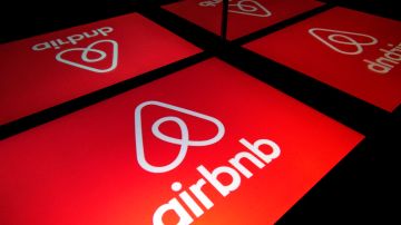 This illustration picture taken on November 22, 2019, shows the logo of the online lodging service Airbnb displayed on a tablet in Paris. (Photo by Lionel BONAVENTURE / AFP) (Photo by LIONEL BONAVENTURE/AFP via Getty Images)
