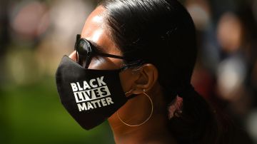 A protester wears a protective face mask with Black Lives Matter written on the fabric at a gathering in support of the Black Lives Matter movement on Woodhouse Moor in Leeds in northern England on June 21, 2020, in the aftermath of the death of unarmed black man George Floyd in police custody in the US. (Photo by Oli SCARFF / AFP) (Photo by OLI SCARFF/AFP via Getty Images)