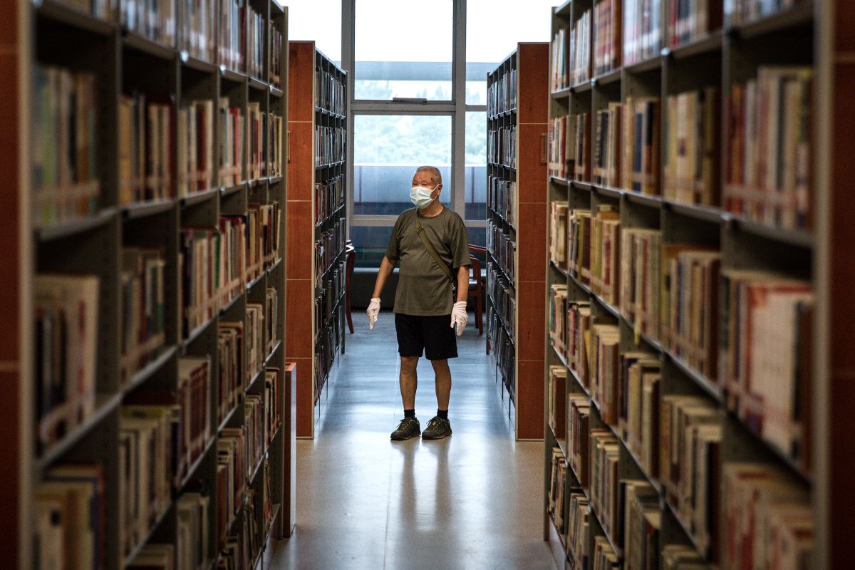 WUHAN, CHINA - JUNE 14: (CHINA OUT)Resident wear the protective gloves and mask while read at the Hubei Provincial Library on  June 14,2020 in Wuhan,Hubei Province,China. Wuhan hit hard by COVID-19, on Sunday reopened five major public cultural venues in the latest move to return to normalcy after the epidemic tapered off. The venues included the provincial museum, the provincial library, the memorial hall of the Xinhai Revolution, the provincial art museum and the mass art center, all located in the provincial capital Wuhan. All the five facilities require reservations in advance and have placed caps on the daily number of visitors.Since June 13,2020. the response level of public health emergencies in Hubei Province has been response to level 3.