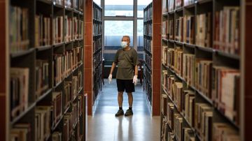 WUHAN, CHINA - JUNE 14: (CHINA OUT)Resident wear the protective gloves and mask while read at the Hubei Provincial Library on  June 14,2020 in Wuhan,Hubei Province,China. Wuhan hit hard by COVID-19, on Sunday reopened five major public cultural venues in the latest move to return to normalcy after the epidemic tapered off. The venues included the provincial museum, the provincial library, the memorial hall of the Xinhai Revolution, the provincial art museum and the mass art center, all located in the provincial capital Wuhan. All the five facilities require reservations in advance and have placed caps on the daily number of visitors.Since June 13,2020. the response level of public health emergencies in Hubei Province has been response to level 3.