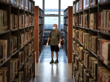 WUHAN, CHINA - JUNE 14: (CHINA OUT)Resident wear the protective gloves and mask while read at the Hubei Provincial Library on June 14,2020 in Wuhan,Hubei Province,China. Wuhan hit hard by COVID-19, on Sunday reopened five major public cultural venues in the latest move to return to normalcy after the epidemic tapered off. The venues included the provincial museum, the provincial library, the memorial hall of the Xinhai Revolution, the provincial art museum and the mass art center, all located in the provincial capital Wuhan. All the five facilities require reservations in advance and have placed caps on the daily number of visitors.Since June 13,2020. the response level of public health emergencies in Hubei Province has been response to level 3.