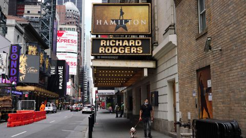 NEW YORK, NEW YORK - JUNE 29: A person walks a dog under the marquee of Hamilton: An American Musical at the Richard Rodgers Theatre on June 29, 2020 in New York City. Broadway will remain closed until 2021 due to the ongoing coronavirus pandemic. (Photo by Cindy Ord/Getty Images)