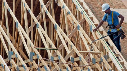 Workers complete the final phases of a roof on a new townhouse under construction September 7, 2012 in Ashburn, Virginia.    AFP PHOTO / Paul J. RICHARDS (Photo by Paul J. RICHARDS / AFP) (Photo by PAUL J. RICHARDS/AFP via Getty Images)