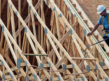 Workers complete the final phases of a roof on a new townhouse under construction September 7, 2012 in Ashburn, Virginia. AFP PHOTO / Paul J. RICHARDS (Photo by Paul J. RICHARDS / AFP) (Photo by PAUL J. RICHARDS/AFP via Getty Images)