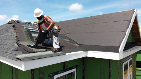 UNIONDALE, NEW YORK - MAY 27: An aerial view of a construction worker roofing an apartment home on May 27, 2020 in Uniondale, New York. The residential housing project by Garden City developers Engel Burman will provide approximately 150 construction jobs, help address a dire housing shortage, and support the County by retaining young professionals and senior citizens from fleeing the region. Today is the first day of Phase 1 of the state’s economic reopening plan on Long Island. Businesses that can partially re-open include construction, manufacturing, and in-store pick-up for retail establishments. (Photo by Al Bello/Getty Images)
