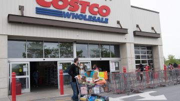 Shoppers walk out with full carts from a Costco store in Washington, DC, on May 5, 2020. - Big-box retailer Costco is limiting consumer purchases of meat in the wake of shutdowns of US processing plants due to the coronavirus.Costco, which has about 440 stores in the United States, is limiting purchases to three items among beef, pork and poultry products, the company said on its website. (Photo by Nicholas Kamm / AFP) (Photo by NICHOLAS KAMM/AFP via Getty Images)
