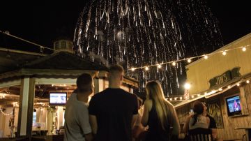 People watch fireworks from the Sand Bar on August 21, 2015 in Oak Bluffs, Massachusetts on Martha's Vineyard. AFP PHOTO/BRENDAN SMIALOWSKI        (Photo credit should read BRENDAN SMIALOWSKI/AFP via Getty Images)