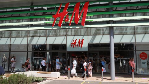 RUSHDEN, UNITED KINGDOM - JUNE 15: Queues form at H&M store at the Rushden Lakes shopping complex on June 15, 2020 in Rushden, United Kingdom. The British government have relaxed coronavirus lockdown laws significantly from Monday June 15, allowing zoos, safari parks and non-essential shops to open to visitors. Places of worship will allow individual prayers and protective facemasks become mandatory on London Transport. (Photo by David Rogers/Getty Images)