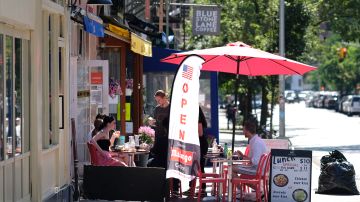 NEW YORK, NEW YORK - JUNE 22: A restaurant in the West Village serves customers seated at sidewalk tables as the city moves into Phase 2 of re-opening following restrictions imposed to curb the coronavirus pandemic on June 22, 2020 in New York City. Phase 2 permits the reopening of offices, in-store retail, outdoor dining, barbers and beauty parlors and numerous other businesses. Phase 2 is the second of four-phased stages designated by the state.  (Photo by Dimitrios Kambouris/Getty Images)