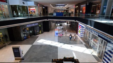 People walk through an empty Westfield Santa Anita shopping mall on June 12, 2020 in Arcadia, California, as Phase 3 in Los Angeles County's battle with the coronavirus pandemic is underway with businesses reopening. (Photo by Frederic J. BROWN / AFP) (Photo by FREDERIC J. BROWN/AFP via Getty Images)
