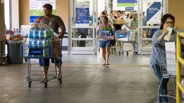 HONOLULU, HI - AUGUST 22:   Crowds of shoppers with shopping carts full of supplies for Hurricane Lane exit Sams Club on Wednesday, August 22, 2018 in Honolulu, Hi. Lane is a high-end Category 4 hurricane and remains a threat to the entire island chain. (Photo by Kat Wade/Getty Images)