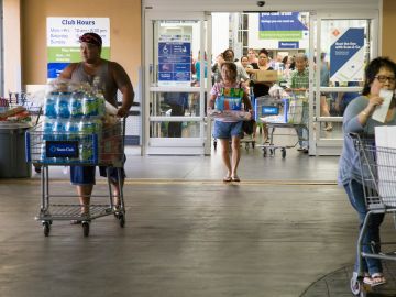 HONOLULU, HI - AUGUST 22:   Crowds of shoppers with shopping carts full of supplies for Hurricane Lane exit Sams Club on Wednesday, August 22, 2018 in Honolulu, Hi. Lane is a high-end Category 4 hurricane and remains a threat to the entire island chain. (Photo by Kat Wade/Getty Images)