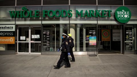 NEW YORK, NEW YORK - APRIL 14: Two New York City Police Department Traffic Enforcement agents walk past the Whole Foods Market on April 14, 2020 in the Brooklyn borough of New York City. (Photo by Justin Heiman/Getty Images)