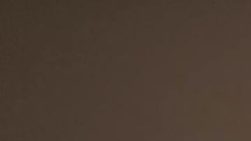 woman-sitting-on-sofa-while-looking-at-phone-with-laptop-on-920382