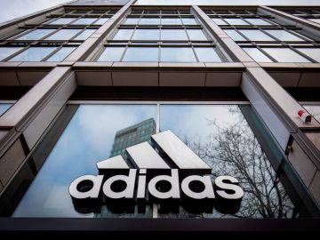 The logo of German sporting goods company Adidas is pictured at one of the company's outlets in Berlin on March 29, 2020. - Major retailers in Germany say they plan to stop paying rent for stores that were told to close in order to slow the pandemic. Adidas is leading the charge, along with shoe chain Deichmann and Swedish clothing giant H&M. (Photo by Odd ANDERSEN / AFP) (Photo by ODD ANDERSEN/AFP via Getty Images)