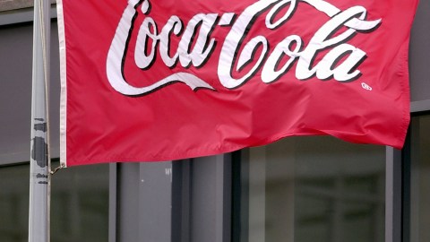 ATLANTA, GA - JANUARY 31: A flag waves in the breeze outside Coca-Cola world headquarters January 31, 2003 in Atlanta, Georgia. Coca-Cola has announced plans to cut 1,000 workers as part of a massive reorganization of its North American operations. Of those jobs, about 500 will be pared from Atlanta. The move is the latest of many major changes at Coke, which has a new president and is pushing to integrate several operations - notably Coca-Cola North America, Coke Fountain and Minute Maid (Photo by Erik S. Lesser/Getty Images)