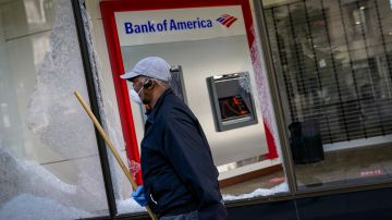 WASHINGTON, DC - JUNE 01: A worker cleans up near a Bank of America that was damaged during overnight unrest, June 1, 2020 in Washington, DC. Protests and riots continue across American following the death of George Floyd, who died after being restrained by Minneapolis police officer Derek Chauvin. Chauvin, 44, was charged last Friday with third-degree murder and second-degree manslaughter. (Photo by Drew Angerer/Getty Images)
