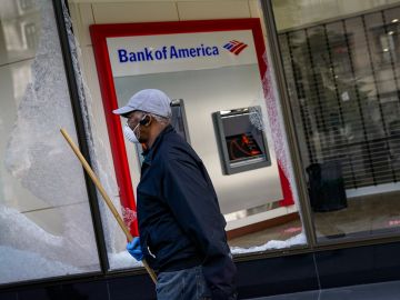 WASHINGTON, DC - JUNE 01: A worker cleans up near a Bank of America that was damaged during overnight unrest, June 1, 2020 in Washington, DC. Protests and riots continue across American following the death of George Floyd, who died after being restrained by Minneapolis police officer Derek Chauvin. Chauvin, 44, was charged last Friday with third-degree murder and second-degree manslaughter. (Photo by Drew Angerer/Getty Images)