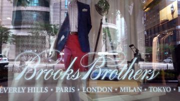 CHICAGO, ILLINOIS - JULY 08: The Brooks Brothers logo is painted on the window of a closed store along the Magnificent Mile on July 08, 2020 in Chicago, Illinois. The retailer which was founded in 1818 and currently has more than 500 stores worldwide filed for bankruptcy protection today.  (Photo by Scott Olson/Getty Images)