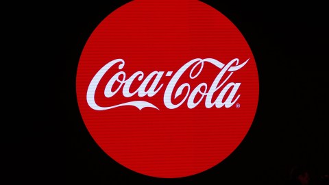 A picture shows the logo of the Coca-Cola company during the presentation of a new advertising campaign on January 19, 2016 in Paris. / AFP / PATRICK KOVARIK (Photo credit should read PATRICK KOVARIK/AFP via Getty Images)