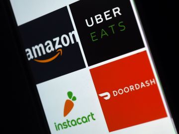 This illustration picture shows delivery applications logos from Amazon, Uber Eats, Instacart and Doordash displayed on a smartphone on April 10, 2020, in Arlington, Virginia - More and more people use the delivery apps as they are sheltering at home,avoiding going out as much as possible due to the coronavirus outbreak. (Photo by Olivier DOULIERY / AFP) (Photo by OLIVIER DOULIERY/AFP via Getty Images)