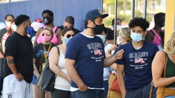 People wearing face masks wait in line to shop at Ikea in Carson, California on July 4, 2020 the US Independence Day holiday. (Photo by Robyn Beck / AFP) (Photo by ROBYN BECK/AFP via Getty Images)