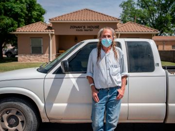 Raymond Blanton, 66, poses in front of JonahÕs House Food Bank on May 7, 2020 in Carlsbad, New Mexico. - Blanton came to get some groceries to get him through the month as he has not been able to rent out his trailer in a town where finding a rental property was extremely difficult and expensive just months ago. Waiting for an upturn or pulling out, a dilemma faced in recent weeks by oil industry workers in Carlsbad, in the southwestern United States, where the sharp drop in oil prices has dealt a blow to the local economy. (Photo by Paul Ratje / AFP) (Photo by PAUL RATJE/AFP via Getty Images)