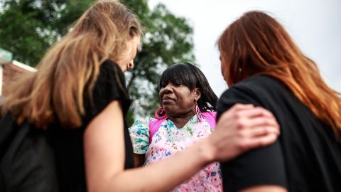 Women pray during a ceremony for the 155th anniversary of Juneteenth near the site where George Floyd died in police custody in Minneapolis, Minnesota, on June 19, 2020. - The US marks the end of slavery by celebrating Juneteenth, with the annual unofficial holiday taking on renewed significance as millions of Americans confront the nation's living legacy of racial injustice. (Photo by Kerem Yucel / AFP) (Photo by KEREM YUCEL/AFP via Getty Images)