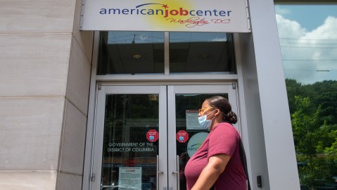 A woman walks past the the DC Department of Employment Services American Job Center, which assists in finding employment for out of work DC residents, in Washington, DC, July 16, 2020. - Americans worry as unemployment benefits are due to end soon. (Photo by SAUL LOEB / AFP) (Photo by SAUL LOEB/AFP via Getty Images)