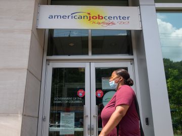A woman walks past the the DC Department of Employment Services American Job Center, which assists in finding employment for out of work DC residents, in Washington, DC, July 16, 2020. - Americans worry as unemployment benefits are due to end soon. (Photo by SAUL LOEB / AFP) (Photo by SAUL LOEB/AFP via Getty Images)