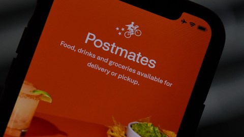 This illustration photo taken on June 30, 2020 shows the logo of delivery app Postmates on a smartphone screen in Los Angeles. - Uber is in talks to buy food delivery app Postmates in a multibillion dollar deal, US media reported. (Photo by Chris DELMAS / AFP) (Photo by CHRIS DELMAS/AFP via Getty Images)