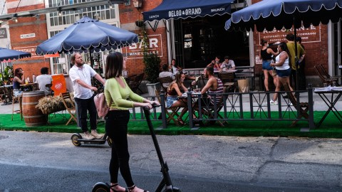 NEW YORK, NY - JULY 04: People dine al fresco in Little Italy on Mulberry Street between Hester and Broome Streets on July 4, 2020 in the Manhattan borough of New York City. Mayor Bill de Blasio has expanded and combined the popular programs, Open Streets and Open Restaurants, as the city opens up streets to outdoor dining as COVID-19 cases ease. (Photo by Byron Smith/Getty Images)