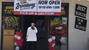 A woman walks into a restaurant in Glendale, California, on July 2, 2020 after Los Angeles County restaurants were force by state order to shut their doors again to dine-in eating following a spike in COVID-19 cases.F (Photo by Robyn Beck / AFP) (Photo by ROBYN BECK/AFP via Getty Images)