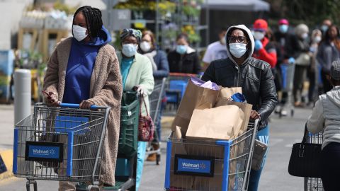 UNIONDALE, NEW YORK - APRIL 17:  People wearing masks and gloves wait to enter a Walmart on April 17, 2020 in Uniondale, New York. The World Health Organization declared coronavirus (COVID-19) a global pandemic on March 11th.  (Photo by Al Bello/Getty Images)