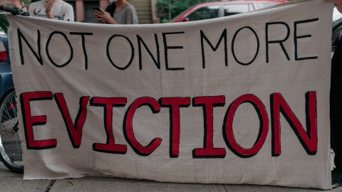 NEW YORK, NY - JULY 31: Housing activists gather to protest alleged tenant harassment by a landlord and call for cancellation of rent in the Crown Heights neighborhood on July 31, 2020 in Brooklyn, New York. Since the onset of the coronavirus crisis, millions of Americans have fallen behind on rent payments, leading many to speculate that an eviction crisis and drastic rise in homelessness is inevitable unless drastic action is taken by state and federal lawmakers. (Photo by Scott Heins/Getty Images)