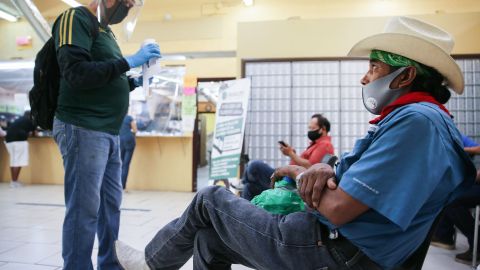 CALEXICO, CALIFORNIA - JULY 24: Faustino (R) and Antonio (L), who are both currently unemployed, wait after filling out unemployment forms in a bookkeeping shop near the U.S.-Mexico border in Imperial County, which has been hard-hit by the COVID-19 pandemic, on July 24, 2020 in Calexico, California. Unemployment claims in California have reached their highest levels in almost three months with surging coronavirus cases upending plans to reopen the economy. Imperial County currently suffers from the highest death rate and near-highest infection rate from COVID-19 in California. The rural county, which is 85 percent Latino, borders Mexico and Arizona and endures high poverty rates and air pollution while also being medically underserved. In California, Latinos make up about 39 percent of the population but account for 55 percent of confirmed coronavirus cases. (Photo by Mario Tama/Getty Images)