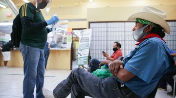 CALEXICO, CALIFORNIA - JULY 24: Faustino (R) and Antonio (L), who are both currently unemployed, wait after filling out unemployment forms in a bookkeeping shop near the U.S.-Mexico border in Imperial County, which has been hard-hit by the COVID-19 pandemic, on July 24, 2020 in Calexico, California. Unemployment claims in California have reached their highest levels in almost three months with surging coronavirus cases upending plans to reopen the economy. Imperial County currently suffers from the highest death rate and near-highest infection rate from COVID-19 in California. The rural county, which is 85 percent Latino, borders Mexico and Arizona and endures high poverty rates and air pollution while also being medically underserved. In California, Latinos make up about 39 percent of the population but account for 55 percent of confirmed coronavirus cases.  (Photo by Mario Tama/Getty Images)