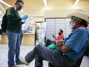 CALEXICO, CALIFORNIA - JULY 24: Faustino (R) and Antonio (L), who are both currently unemployed, wait after filling out unemployment forms in a bookkeeping shop near the U.S.-Mexico border in Imperial County, which has been hard-hit by the COVID-19 pandemic, on July 24, 2020 in Calexico, California. Unemployment claims in California have reached their highest levels in almost three months with surging coronavirus cases upending plans to reopen the economy. Imperial County currently suffers from the highest death rate and near-highest infection rate from COVID-19 in California. The rural county, which is 85 percent Latino, borders Mexico and Arizona and endures high poverty rates and air pollution while also being medically underserved. In California, Latinos make up about 39 percent of the population but account for 55 percent of confirmed coronavirus cases. (Photo by Mario Tama/Getty Images)