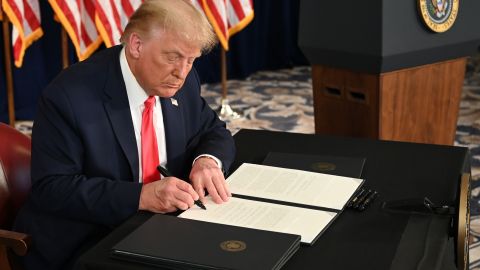 US President Donald Trump signs executive orders extending coronavirus economic relief, during a news conference in Bedminster, New Jersey, on August 8, 2020. (Photo by JIM WATSON / AFP) (Photo by JIM WATSON/AFP via Getty Images)