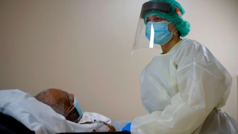 A healthcare worker tends to a patient in the Covid-19 Unit at United Memorial Medical Center in Houston, Texas, July 2, 2020. - Despite its renowned medical center with the largest agglomeration of hospitals and research laboratories in the world, Houston is on the verge of being overwhelmed by cases of coronavirus exploding in Texas. (Photo by Mark Felix / AFP) / RESTRICTED TO EDITORIAL USE
TO GO WITH AFP STORY by Julia Benarrous: "Covid-19: Houston's hospital system underwater" (Photo by MARK FELIX/AFP via Getty Images)