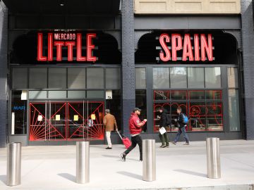 NEW YORK, NEW YORK - MARCH 27: People walk by Mercado Little Spain in the newly opened Hudson Yards development on March 27, 2019 in New York City. The 35,000-square-foot food hall, which had a soft opening on March 15, was created by famed chef José Andrés. Mercado Little Spain features three full-service restaurants; wine, tapas, and cocktail bars; a coffee shop; and nearly a dozen food stalls. (Photo by Spencer Platt/Getty Images)