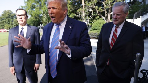 WASHINGTON, DC - JULY 29: U.S. President Donald Trump speaks as Secretary of Treasury Steven Mnuchin (L) and White House Chief of Staff Mark Meadows (R) listen prior to Trump's Marine One departure from the South Lawn of the White House July 29, 2020 in Washington, DC. President Trump is traveling to visit the Double Eagle Energy oil rig in Midland, Texas, and will attend a fundraising luncheon for the Republican Party and his reelection campaign. (Photo by Alex Wong/Getty Images)