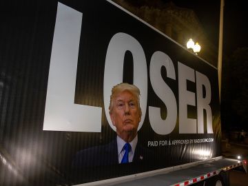 WASHINGTON, DC - AUGUST 24:  A truck carrying an anti President Donald Trump sign is shown parked outside the Andrew Mellon Auditorium where speakers took park in opening night of the virtual  Republican National Convention on August 24, 2020 in Washington, DC. The Republican Party formally nominated President Donald Trump for a second term in the White House Monday, one of the first acts of a GOP convention that has been dramatically scaled down to prevent the spread of the coronavirus. (Photo by Tasos Katopodis/Getty Images)