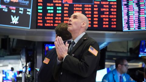 TOPSHOT - Traders work on the floor at the opening bell of the Dow Industrial Average at the New York Stock Exchange on March 18, 2020 in New York. - Wall Street stocks resumed their downward slide early Wednesday as the economic toll mounts from the rapid near-shutdown of key industrial and services sectors.About 15 minutes into trading, the Dow Jones Industrial Average stood at 20,040.66, down around 1,200 points or 5.6 percent. (Photo by Bryan R. Smith / AFP) (Photo by BRYAN R. SMITH/AFP via Getty Images)
