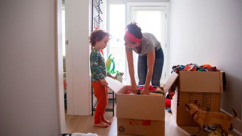 Levi Benjamin-Brown, 5, helps him mother Kyala Brown unpack does of toys at their new home in El Cerrito, California on September 11, 2020. - Brown's family previously lived in San Francisco but recently moved to the East Bay in order to be closer to family because of Covid-19 and babysitting needs. A work-from-home trend kicked into overdrive by the pandemic is disrupting a city long a Mecca for tech talent. Tech workers who flocked to San Francisco to be near Google, Facebook, Pinterest, Twitter and other internet firms are moving to parts of the US where life is slower and the cost of living cheaper. (Photo by Brittany Hosea-Small / AFP) (Photo by BRITTANY HOSEA-SMALL/AFP via Getty Images)
