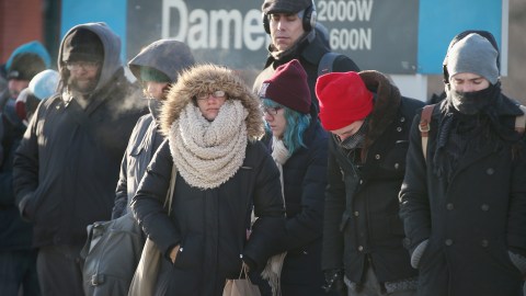 CHICAGO, IL - JANUARY 07: Passengers heading into downtown wait on an "L" platform for the train to arrive in below zero temperatures on January 7, 2014 in Chicago, Illinois. Platforms were crowded and trains were delayed because doors on the trains kept freezing open. Chicago is experiencing its third consecutive day of below zero temperatures. (Photo by Scott Olson/Getty Images)