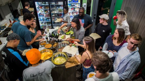 Young artists have dinner in the UP(st)ART house in Los Angeles, California, on October 24, 2019. - Kay Wilson packed up her life in a hurry and moved to Los Angeles ... only to find that what she paid in Pennsylvania for a nice studio apartment would only get her a 2.9-square-meter box in California.Her new home is a capsule, inspired by the famous hotels in Japan.Wilson arrived a month ago at UP(st)ART, a community for young people with artistic aspirations in need of an affordable place to live. Each room contains up to six capsules, which Wilson describes as "cozy." They contain a single bed, a bar for hanging clothes, a few compartments for storing shoes and other items, and an air vent. (Photo by Apu Gomes / AFP) (Photo by APU GOMES/AFP via Getty Images)