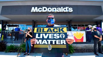 Activists protest in front of a McDonalds in Los Angeles, California, on July 20, 2020 during a Strike For Black Lives rally. - The Strike For Black Lives rally, which brought together labour unions, fast food restaurant workers and racial and social justice groups and a car caravan in support of Black Lives Matter, is taking place in numerous cities across America. Tens of thousands of union workers joined social and racial justice advocates in more than 25 US cities in walking off the job July 20, 2020, in support of dismantling systemic racism. (Photo by Frederic J. BROWN / AFP) (Photo by FREDERIC J. BROWN/AFP via Getty Images)
