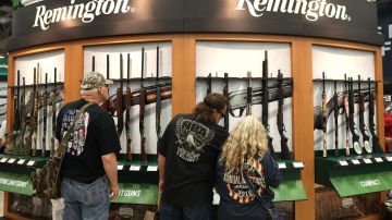 DALLAS, TX - MAY 05:  Attendees look at a display of Remington shotguns during the NRA Annual Meeting & Exhibits at the Kay Bailey Hutchison Convention Center on May 5, 2018 in Dallas, Texas.  The National Rifle Association's annual meeting and exhibit runs through Sunday.  (Photo by Justin Sullivan/Getty Images)